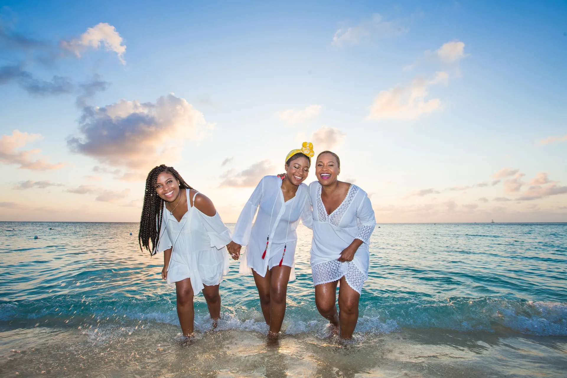 three dark-skinned women on beach in belize
